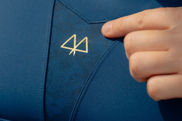 Blue athletic bra with a logo on a person wearing it.
