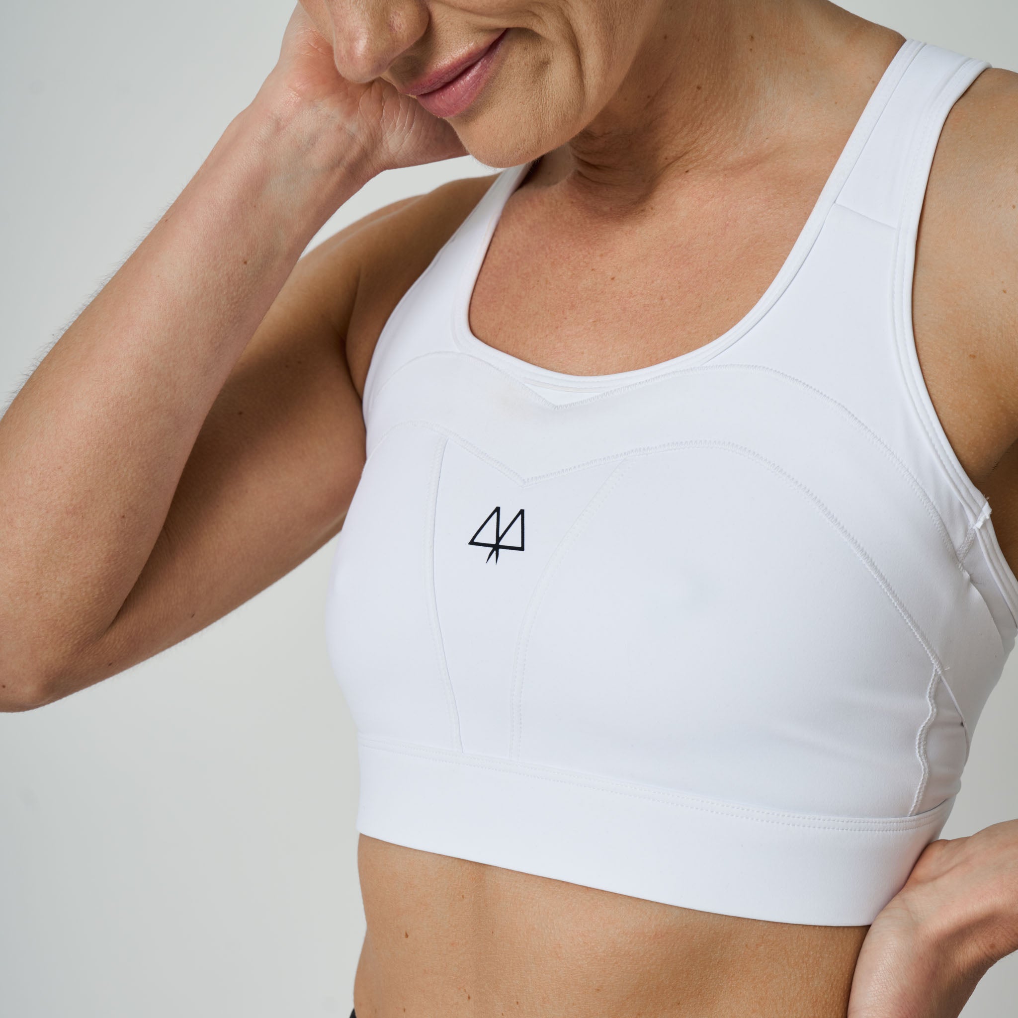 White sports bra with a MAAREE logo on a neutral background