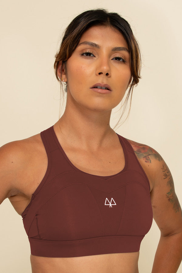 Woman in Burgundy high-support sports bra facing forward, showing the White MAAREE logo on the chest.